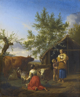 A Woman Milking a Goat Outside a Barn